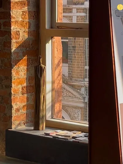 We are drawn to what is raw. To light caught in stone, to air between brick. This wooden sculpture on a windowsill, with the heritage building outside, captures the quiet, material truths that inspire us.