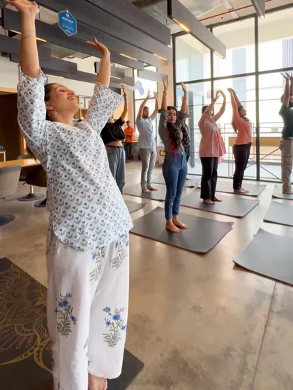 The joy on everyone's face says it all. This is a moment from a corporate yoga session where we focused on simple, uplifting stretches to release tension from the neck, shoulders, and back. You can see how accessible and enjoyable it is for the whole team.