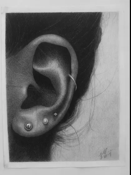 Another student's impressive ear study, demonstrating their ability to render metallic piercings and soft skin textures.