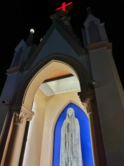 A low-angle shot of a statue of Mother Mary, creating a sense of reverence and peace.
