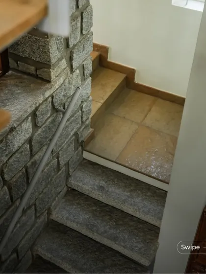 The stone staircase in the Shashidhar Residence, showing how natural, rugged materials can be used to create elegant and durable architectural features.