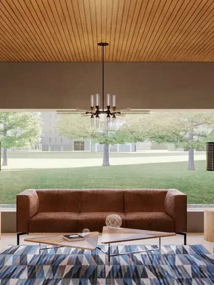 The waiting lounge for the marketing office, designed to feel open and inviting. A large picture window floods the space with natural light and offers an expansive view of the property. The wood-louvered ceiling and sleek furniture create a look of understated luxury.