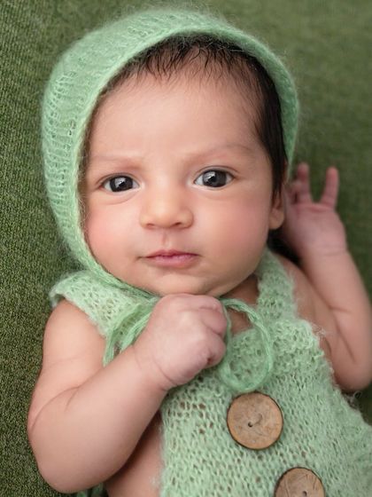 "Really? This is the outfit you picked?" This nine-day-old's expressive, wide-eyed look is a funny reminder that even the tiniest babies have a big personality.
