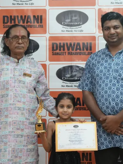 A student with her father and our senior guru, celebrating her achievement.
