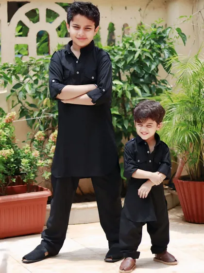 To showcase this ethnic wear for kids, I focused on capturing the charming and confident personalities of these two brothers. The classic black kurtas stand out against the natural greenery, blending traditional style with a modern, sophisticated feel.