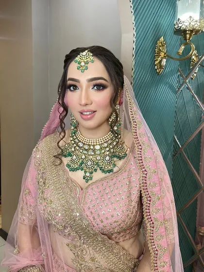 A sweet bride ready for her big day. We gave her a soft, sweet pink touch on the eyes to complement her beautiful pink lehenga.