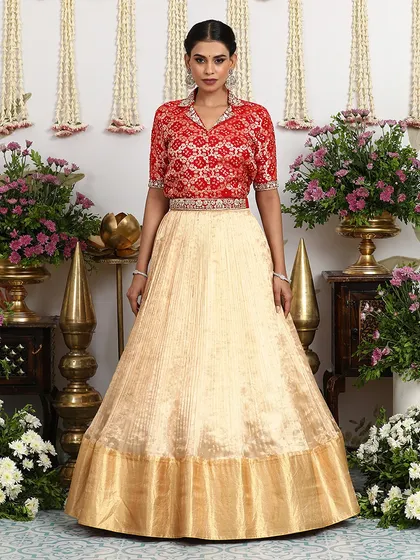 A front-facing view that captures the complete elegance of the collared blouse and pleated silk lehenga combination.