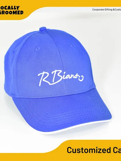 A bright blue cap with a clean, white embroidered logo for R Biandy. The contrasting colors make the branding stand out, perfect for promotional events.
