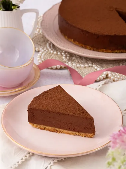 For the true chocolate lover, a slice of my Belgian Chocolate Mousse Cake. This dessert is pure, simple decadence with a rich, airy chocolate mousse on a crisp base, finished with a dusting of fine cocoa powder.