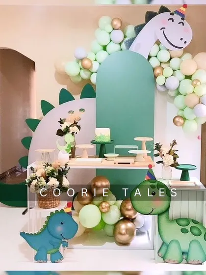 Get ready for a dino-mite party! This friendly dinosaur theme is perfect for a little one's birthday, featuring cute dino cutouts, a lush green color scheme, and a multi-level display for cakes and treats.