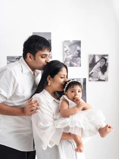 A quiet, loving moment with the whole family. This portrait captures the protective and gentle nature of new parenthood.