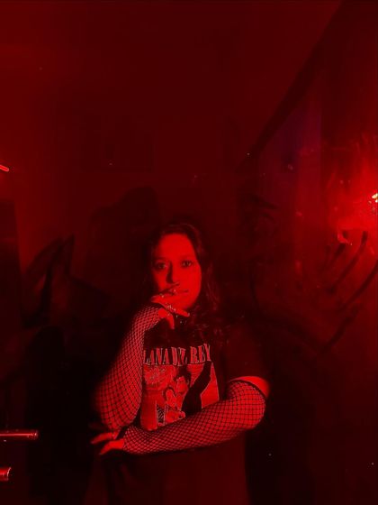 A moody, red-lit portrait from an emo-themed night. This shows my versatility and willingness to play with different themes and aesthetics for a curated event.