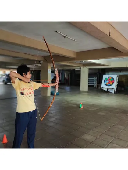A student practices her form at our indoor range. This setup allows us to train year-round, regardless of the weather.