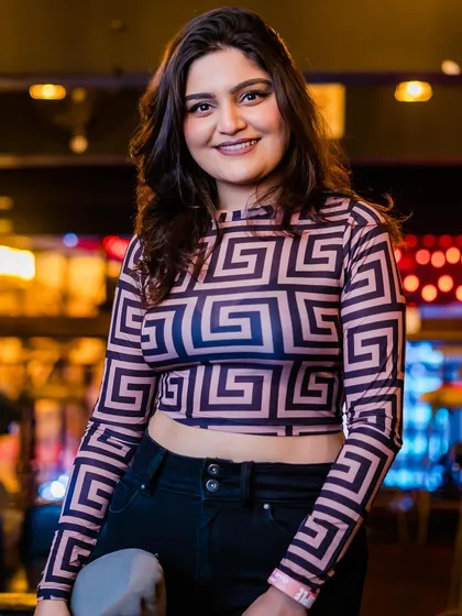 A guest posing in a patterned top.