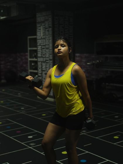 Holding dumbbells, I'm focused and ready for the next set. Proper form with free weights like these is crucial for building functional strength and muscle, a core principle of my training programs.