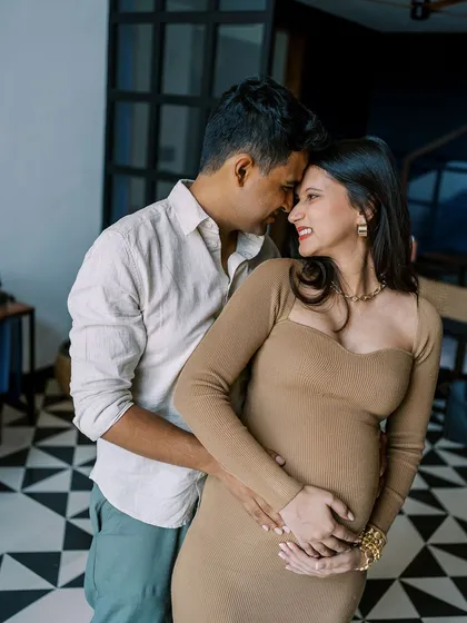 The connection between this couple is so clear as they share a happy, close moment. Their home's unique architecture with the patterned floor adds a stylish backdrop to their natural interaction.