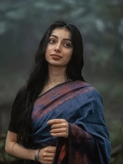 A close-up from the monsoon series, with a soft, thoughtful expression.
