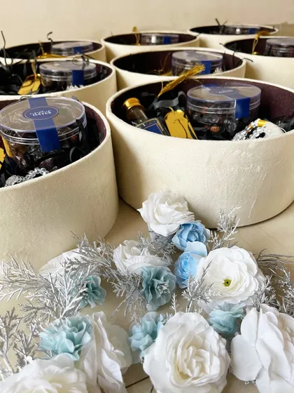 A behind-the-scenes shot of Ramadan hampers being prepared. Each box is filled with care and attention to detail.