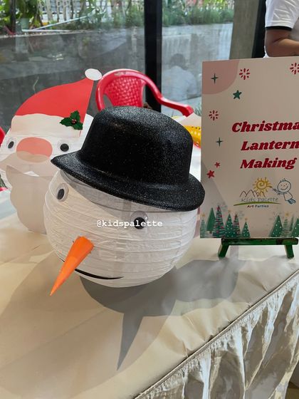 Here is a finished snowman lantern, complete with a carrot nose and a dapper top hat. It's a simple paper craft that kids feel incredibly proud to complete and display.