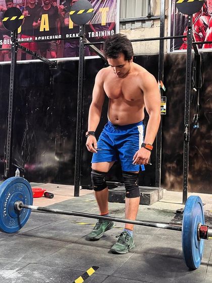 A moment of focus before the next lift. Olympic weightlifting is as much a mental game as it is a physical one. It's about finding your balance and energy before you even touch the bar.