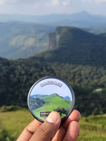 Our Bandaje badge held high, with the stunning cliffs and valleys of the trek in the background.
