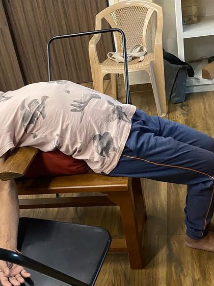 A student in a supported chest-opening pose on a yoga bench. This allows the heart to breathe and is deeply calming for the entire nervous system.