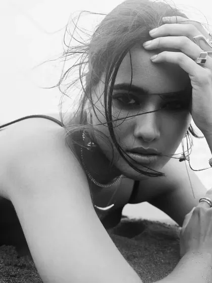 Another powerful black and white image. The contrast highlights the smokey eye and the texture of the hair.