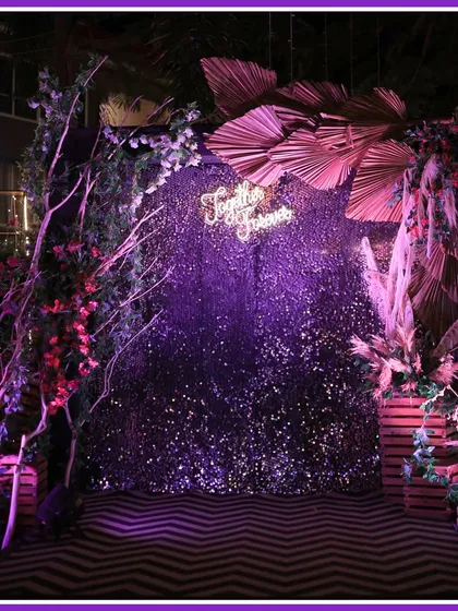 It's all in the details. This boho-chic photo booth with a purple sequin backdrop and a "Together Forever" neon sign was a popular spot for guests all night long.