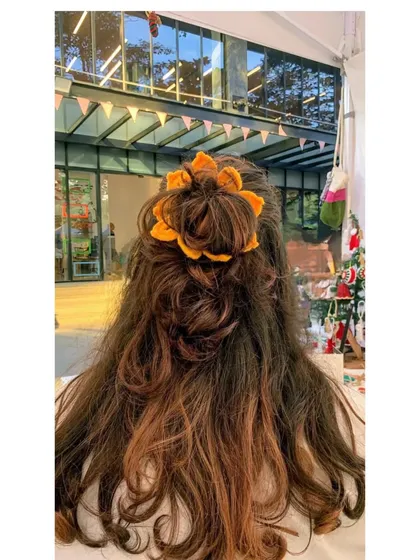 Here’s one of our favorite hair accessories, the handmade sunflower scrunchie. It adds a cheerful, bohemian touch to any hairstyle and is perfect for a good hair day.