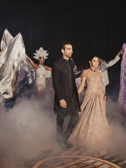 A grand sangeet entry designed to feel immersive without losing intimacy. The couple walked through a path of performers and smoke, setting the stage for an evening that was all about them.