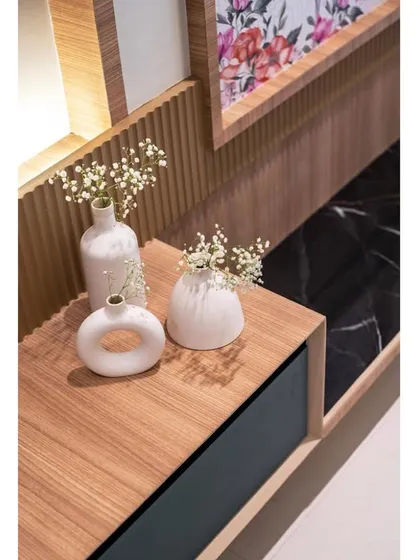 Simple details make a design significant. This close-up shows the minimalist vases and fluted drawer fronts on the TV console.