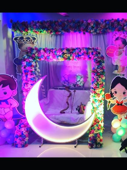 The baby shower setup illuminated with pink and green lights, creating a vibrant and festive mood for the celebration.
