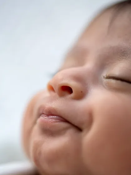 The hint of a sleepy smile and the perfect shape of a newborn's lips. These are the sweet expressions I aim to preserve.