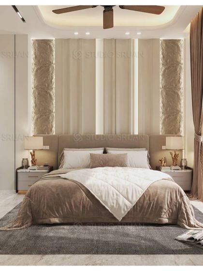 The bed is framed by two textured columns and a simple, upholstered headboard. The overall design is clean, symmetrical, and calming.