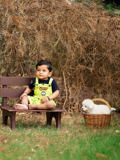 A boy and his furry friend. This heartwarming outdoor portrait captures a gentle moment with a puppy, adding an extra layer of sweetness to the photoshoot.