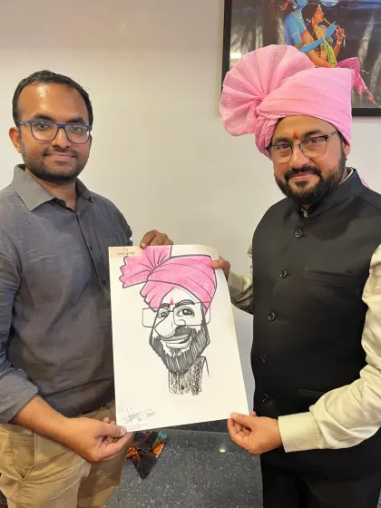 A guest wearing a traditional pheta proudly holds his caricature from a wedding in Barwani. It's great to capture these cultural elements.