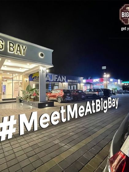 Night vibes and great times. The #MeetMeAtBigBay sign says it all. It's the perfect spot for a late-night pitstop with friends.