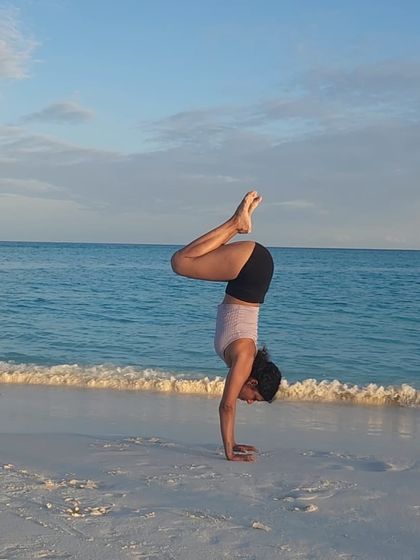 Happiness is a handstand by the sea. The feeling of balancing on my hands with the sound of the waves is pure joy and freedom.