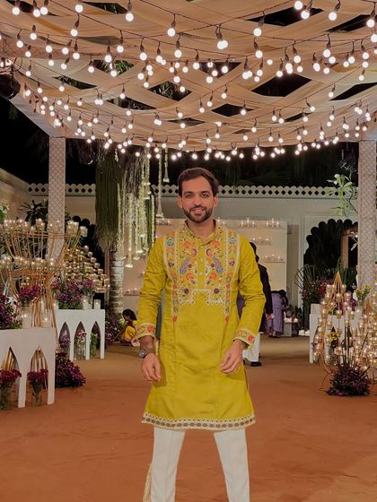 A full frontal view of my embroidered green kurta. I pay attention to detail in my outfits, just as I do in my hosting.