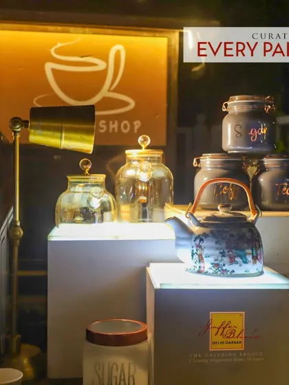 Our beverage counters are curated for every palate. This artistic setup features vintage-style jars for sugar and a beautifully painted teapot, adding a touch of class to the tea and coffee service.