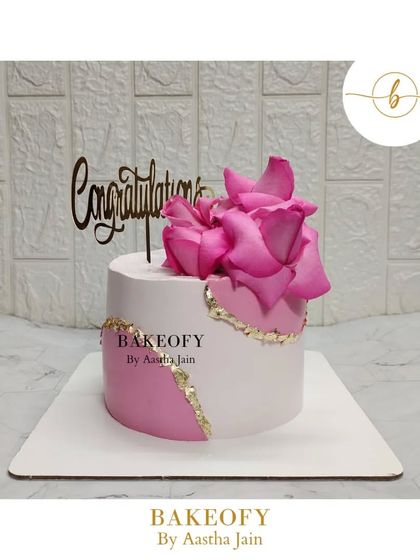 Sweetness framed with pink roses. This is a simple but elegant Lotus Biscoff cake with a fault line design in pink and gold, topped with fresh roses.