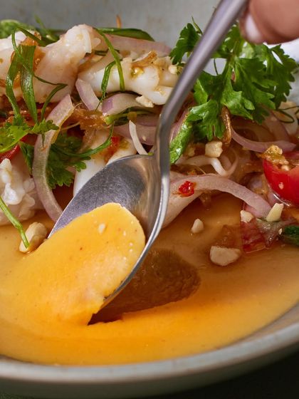 A spoonful of the salad, showing the creamy panna cotta and the tender seafood together.