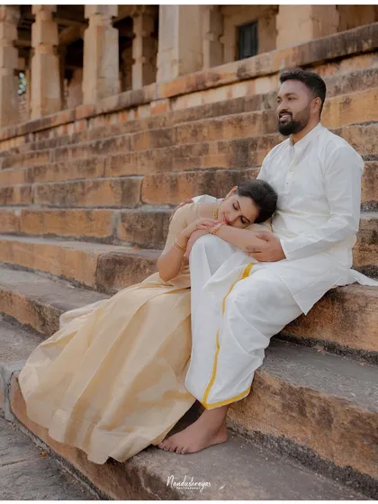 A peaceful moment with the bride-to-be resting her head on her partner's lap on the temple steps.
