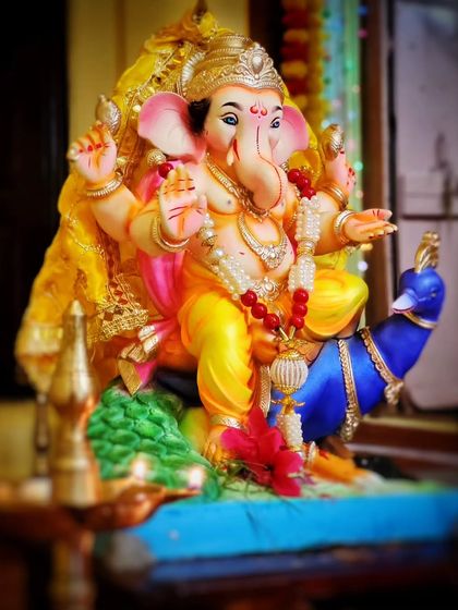 The first glimpse of a beautiful Ganesh idol from my family's celebration in Konkan. The vibrant colors and sharp details make this one of my favorite shots of Bappa.
