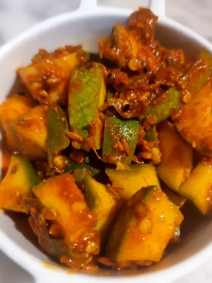 This Ambi Hari Mirchi pickle is a new favorite. It combines the tang of raw mango (ambi) with the mild heat of green chilies. It has become a bestseller for its unique spicy and sour flavour.