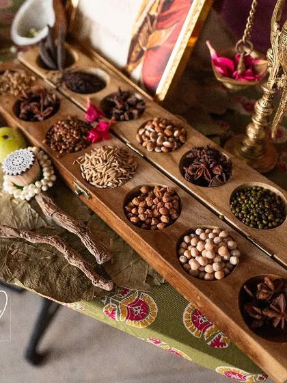 A close-up of the Navadhanyam (nine grains) and heirloom sarees at the legacy counter, a tribute to family heritage.