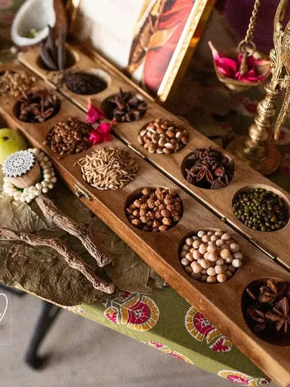 A close-up of the Navadhanyam (nine grains) and heirloom sarees at the legacy counter, a tribute to family heritage.