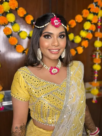 A happy and radiant Simran, with makeup that perfectly complements her bright yellow mehendi outfit.