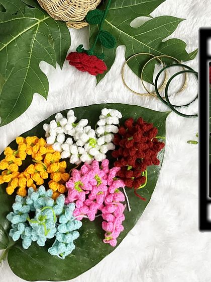 A collection of my colorful gajras laid out on a leaf. This shows the variety of vibrant options available for customization.