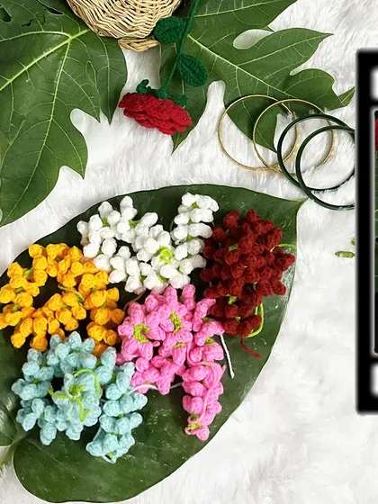 A collection of my colorful gajras laid out on a leaf. This shows the variety of vibrant options available for customization.